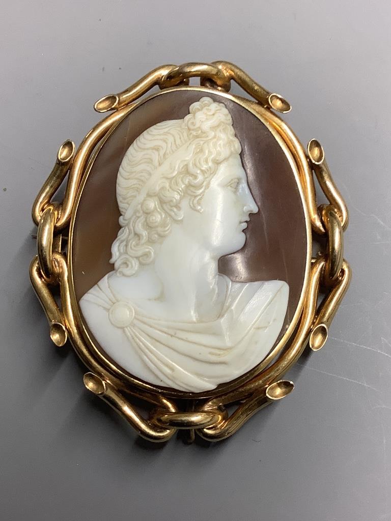 A Victorian yellow metal mounted oval cameo shell brooch, carved with the bust of a lady to sinister, 66mm